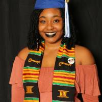 soon to be graduate taking a picture at GradFest